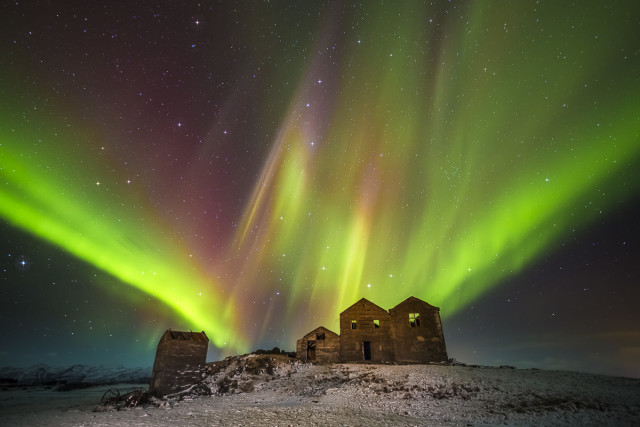 Northern Lights illuminate over the remains of an old farm in Iceland. Native Americans believe the lights to be the spirits of ancestors dancing in the sky.